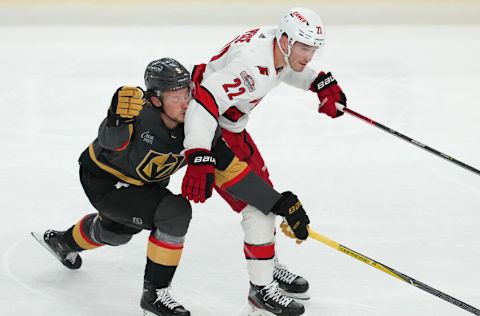 Mar 1, 2023; Las Vegas, Nevada, USA; Carolina Hurricanes defenseman Brett Pesce (22) slows down Vegas Golden Knights center Jack Eichel (9) during the third period at T-Mobile Arena. Mandatory Credit: Stephen R. Sylvanie-USA TODAY Sports