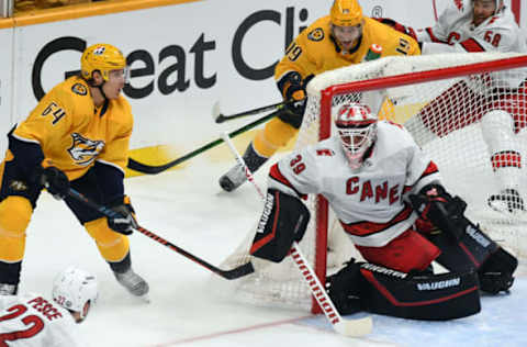 May 27, 2021; Nashville, Tennessee, USA; Nashville Predators center Mikael Granlund (64) has a shot blocked by Carolina Hurricanes goaltender Alex Nedeljkovic (39) during the third period in game six of the first round of the 2021 Stanley Cup Playoffs at Bridgestone Arena. Mandatory Credit: Christopher Hanewinckel-USA TODAY Sports