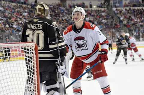 HERSHEY, PA – FEBRUARY 09: Charlotte Checkers right wing Julien Gauthier (12) smiles as Hershey Bears goalie Vitek Vanecek (30) sets a pick and tries to block his path to to behind the net during the Charlotte Checkers vs. Hershey Bears AHL game February 9, 2019 at the Giant Center in Hershey, PA. (Photo by Randy Litzinger/Icon Sportswire via Getty Images)