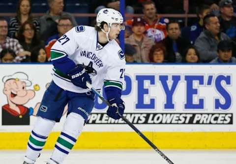 Mar 18, 2016; Edmonton, Alberta, CAN; Vancouver Canucks defensemen Ben Hutton (27) carries the puck against the Edmonton Oilers at Rexall Place. Mandatory Credit: Perry Nelson-USA TODAY Sports