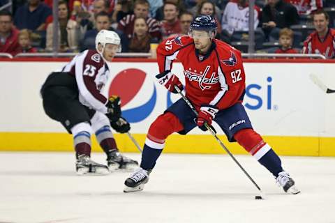 Oct 18, 2016; Washington, DC, USA; Washington Capitals center Evgeny Kuznetsov (92) skates with the puck past Colorado Avalanche center Mikhail Grigorenko (25) in the second period at Verizon Center. Mandatory Credit: Geoff Burke-USA TODAY Sports