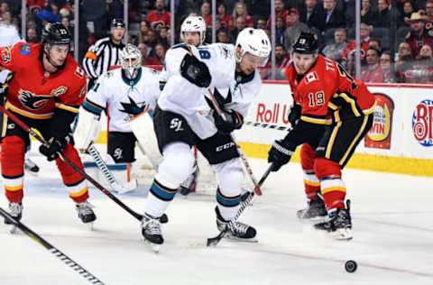 CALGARY, AB – FEBRUARY 07: San Jose Sharks Center Tomas Hertl (48) and Calgary Flames Left Wing Matthew Tkachuk (19) compete for the puck during the third period of an NHL game where the Calgary Flames hosted the San Jose Sharks on February 7, 2019, at the Scotiabank Saddledome in Calgary, AB. (Photo by Brett Holmes/Icon Sportswire via Getty Images)