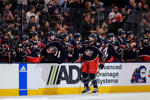 Jan 7, 2023; Columbus, Ohio, USA; Columbus Blue Jackets right wing Kirill Marchenko (right) celebrates with teammates after scoring his hat-trick goal against the Carolina Hurricanes in the third period at Nationwide Arena. Mandatory Credit: Aaron Doster-USA TODAY Sports