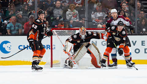 ANAHEIM, CA – MARCH 3: Josh Manson #42, goaltender John Gibson #36 and Hampus Lindholm #47 of the Anaheim Ducks and Nathan MacKinnon #29 of the Colorado Avalanche look on during the first period of the game at Honda Center on March 3, 2019, in Anaheim, California. (Photo by Foster Snell/NHLI via Getty Images) *** Local Caption ***