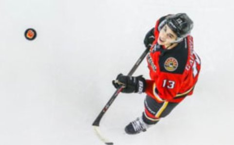 Apr 7, 2016; Calgary, Alberta, CAN; Calgary Flames left wing Johnny Gaudreau (13) controls the puck during the warmup period against the Vancouver Canucks at Scotiabank Saddledome. Mandatory Credit: Sergei Belski-USA TODAY Sports