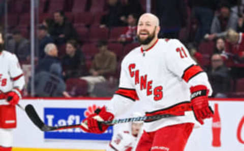 Apr 1, 2023; Montreal, Quebec, CAN; Carolina Hurricanes center Derek Stepan (21) smiles while looking at his teammates during warm-up before the game against the Montreal Canadiens at Bell Centre. Mandatory Credit: David Kirouac-USA TODAY Sports