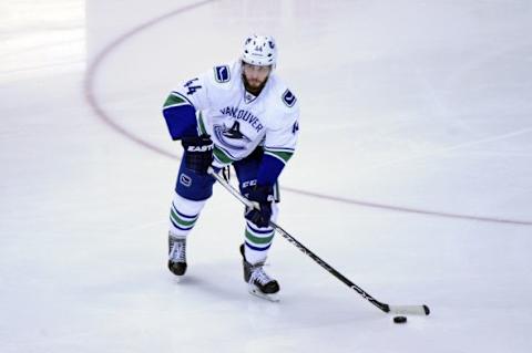 Oct 30, 2015; Glendale, AZ, USA; Vancouver Canucks defenseman Matt Bartkowski (44) passes the puck during the first period against the Arizona Coyotes at Gila River Arena. Mandatory Credit: Matt Kartozian-USA TODAY Sports