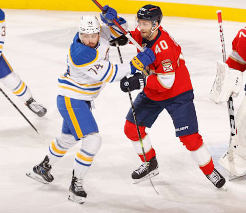 SUNRISE, FL – APRIL 8: Rasmus Asplund #74 of the Buffalo Sabres and Petteri Lindbohm #40 of the Florida Panthers battle in front of the net during the first period at the FLA Live Arena on April 8, 2022 in Sunrise, Florida. (Photo by Joel Auerbach/Getty Images)