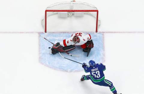 VANCOUVER, BC – DECEMBER 12: Bo Horvat #53 of the Vancouver Canucks takes a shot on Petr Mrazek #34 of the Carolina Hurricanes during their NHL game at Rogers Arena December 12, 2019 in Vancouver, British Columbia, Canada. Vancouver won 1-0. (Photo by Jeff Vinnick/NHLI via Getty Images)