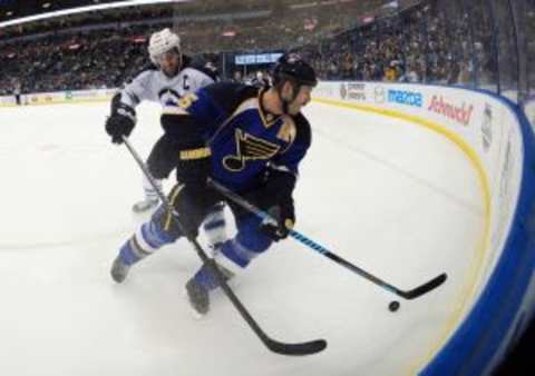 Mar 17, 2014; St. Louis, MO, USA; Winnipeg Jets left wing Andrew Ladd (16) battles St. Louis Blues defenseman Barret Jackman (5) for the puck during the first period at Scottrade Center. Mandatory Credit: Jasen Vinlove-USA TODAY Sports