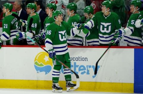 RALEIGH, NC – JANUARY 11: Teuvo Teravainen #86 of the Carolina Hurricanes scores an empty net goal and celebrates with teammates in the bench area during an NHL game against the Los Angeles Kings on January 11, 2020 at PNC Arena in Raleigh, North Carolina. (Photo by Gregg Forwerck/NHLI via Getty Images)