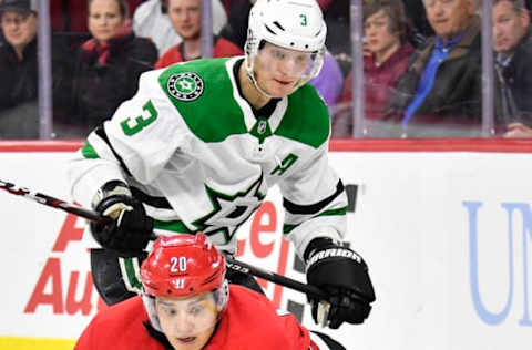 RALEIGH, NORTH CAROLINA – FEBRUARY 25: John Klingberg #3 of the Dallas Stars defends Sebastian Aho #20 of the Carolina Hurricanes during the first period of their game at PNC Arena on February 25, 2020 in Raleigh, North Carolina. (Photo by Grant Halverson/Getty Images)