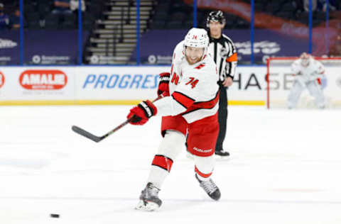 Feb 24, 2021; Tampa, Florida, USA;Carolina Hurricanes defenseman Jaccob Slavin (74) shoots against the Tampa Bay Lightning during the second period at Amalie Arena. Mandatory Credit: Kim Klement-USA TODAY Sports