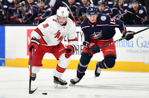 COLUMBUS, OH – JANUARY 16: Sebastian Aho #20 of the Carolina Hurricanes skates the puck away from Jakob Lilja #15 of the Columbus Blue Jackets during the second period of a game on January 16, 2020 at Nationwide Arena in Columbus, Ohio. (Photo by Jamie Sabau/NHLI via Getty Images)