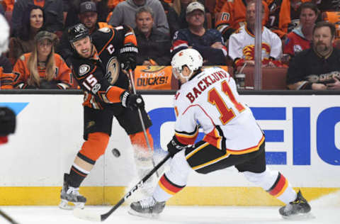 ANAHEIM, CA – APRIL 15: Anaheim Ducks Center Ryan Getzlaf (15) passes the puck around Calgary Flames Center Mikael Backlund (11)(Photo by Chris Williams/Icon Sportswire via Getty Images)