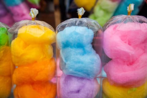 Bags of brightly colored cotton candy in various hues.