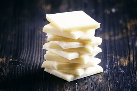 Squares of white chocolate stacked on top of each other.