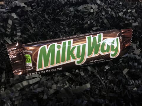 A Milky Way bar on a black background.