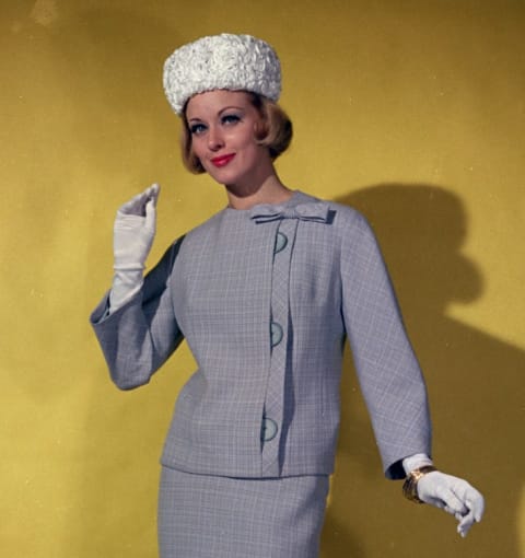 Woman wearing a pillbox hat in the 1960s.