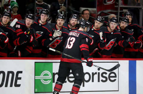 RALEIGH, NC – APRIL 18: Warren Foegele #13 of the Carolina Hurricanes is congratulated by teammates after scoring a goal in Game Four of the Eastern Conference First Round against the Washington Capitals during the 2019 NHL Stanley Cup Playoffs on April 18, 2019 at PNC Arena in Raleigh, North Carolina. (Photo by Gregg Forwerck/NHLI via Getty Images)