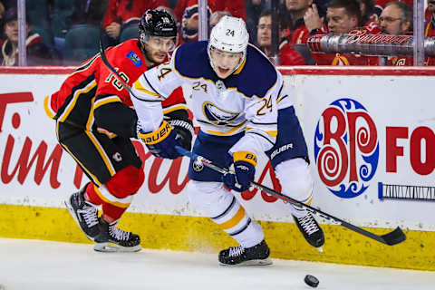 Jan 16, 2019; Calgary, Alberta, CAN; Buffalo Sabres defenseman Lawrence Pilut (24) and Calgary Flames center Derek Ryan (10) battle for the puck during the first period at Scotiabank Saddledome. Mandatory Credit: Sergei Belski-USA TODAY Sports