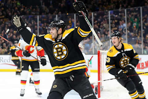 BOSTON, MASSACHUSETTS – JANUARY 03: Jake DeBrusk #74 of the Boston Bruins celebrates after John Moore #27 scored a goal during the game between the Boston Bruins and Calgary Flames at TD Garden on January 03, 2019 in Boston, Massachusetts. (Photo by Maddie Meyer/Getty Images)