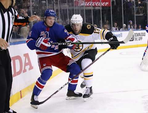 NEW YORK, NEW YORK – FEBRUARY 16: Charlie Coyle #13 of the Boston Bruins checks Kaapo Kakko #24 of the New York Rangers during the second period at Madison Square Garden on February 16, 2020 in New York City. (Photo by Bruce Bennett/Getty Images)