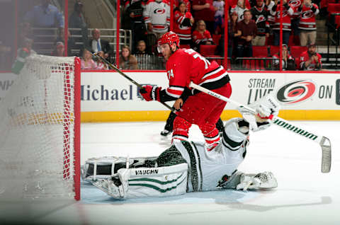 RALEIGH, NC – OCTOBER 7: Jaccob Slavin #74 of the Carolina Hurricanes lifts the puck over a sprawling Alex Stalock #32 of the Minnesota Wild during the shootout of an NHL game on October 7, 2017 at PNC Arena in Raleigh, North Carolina. (Photo by Gregg Forwerck/NHLI via Getty Images)