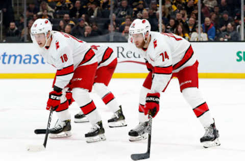 BOSTON, MA – DECEMBER 03: Carolina Hurricanes left wing Ryan Dzingel (18) and Carolina Hurricanes defenseman Jaccob Slavin (74) get ready for a defensive zone face-off during a game between the Boston Bruins and the Carolina Hurricanes on December 3, 2019, at TD Garden in Boston, Massachusetts. (Photo by Fred Kfoury III/Icon Sportswire via Getty Images)