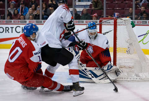 Marco Lehmann #6 of Switzerland tries to fight off the check of Jakub Galvas #10 of the Czech Republic to get a shot on goalie Lukas Dostal #2 of the Czech Republic in (Photo by Rich Lam/Getty Images)