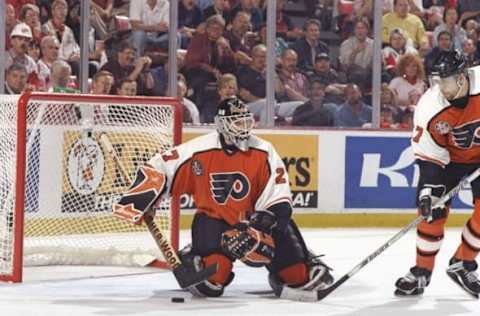 5 Jun 1997: Goaltender Ron Hextall of the Philadelphia Flyers (left) looks on as teammate defenseman Eric Desjardins moves down the ice during a playoff game against the Detroit Red Wings at Joe Louis Arena in Detroit, Michigan. The Red Wings won the game, 6-1. Mandatory Credit: Rick Stewart /Allsport