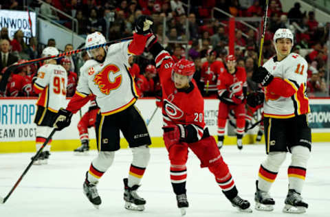 RALEIGH, NC – OCTOBER 29: Sebastian Aho #20 of the Carolina Hurricanes battles for position on the ice with Oliver Kylington #58 of the Calgary Flames during an NHL game on October 29, 2019 at PNC Arena in Raleigh, North Carolina. (Photo by Gregg Forwerck/NHLI via Getty Images)