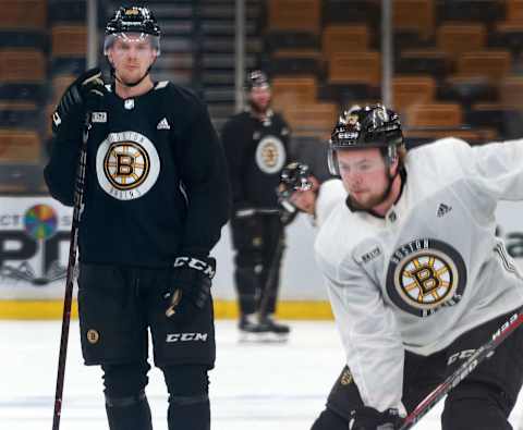 BOSTON – JUNE 5: With Boston Bruins’ Zdeno Chara (not pictured) likely out with a broken jaw, Bruins defenseman Urho Vaakanainen, rear left, is one of the candidates to join Charlie McAvoy, foreground right, in his place during a practice session at TD Garden in Boston in preparation for Game 5 of the 2019 Stanley Cup Finals against the St. Louis Blues on June 5, 2019. (Photo by Jim Davis/The Boston Globe via Getty Images)