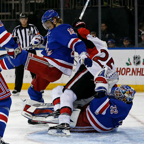 Nov 27, 2016; New York, NY, USA; Ottawa Senators right wing Chris Neil (25) gets tripped up between New York Rangers defenseman Marc Staal (18) and New York Rangers goalie Antti Raanta (32) during the third period at Madison Square Garden. Mandatory Credit: Adam Hunger-USA TODAY Sports