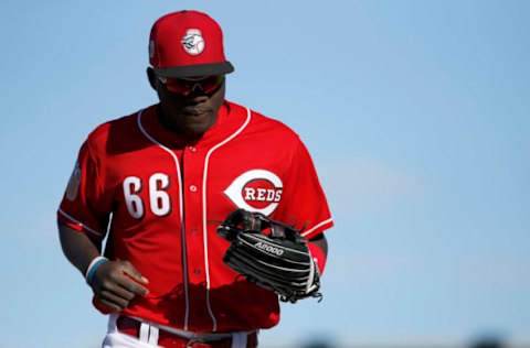 Feb 26, 2017; Goodyear, AZ, USA; Cincinnati Reds right fielder Aristides Aquino (66) returns to the dugout after the top of the ninth inning against the San Francisco Giants at Goodyear Ballpark. Mandatory Credit: Sam Greene/Cincinnati Enquirer via USA TODAY Sports