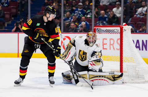 Mar 21, 2023; Vancouver, British Columbia, CAN; Vegas Golden Knights goaltender Jonathan Quick (32) makes a save as Vancouver Canucks forward Nils Aman (88) looks on in the third period at Rogers Arena. Mandatory Credit: Bob Frid-USA TODAY Sports