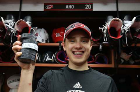 RALEIGH, NC – DECEMBER 07: Sebastian Aho #20 of the Carolina Hurricanes poses with 5 pucks after scoring a hat trick and 2 assists during an NHL game against the Minnesota Wild on December 7, 2019 at PNC Arena in Raleigh, North Carolina. (Photo by Gregg Forwerck/NHLI via Getty Images)