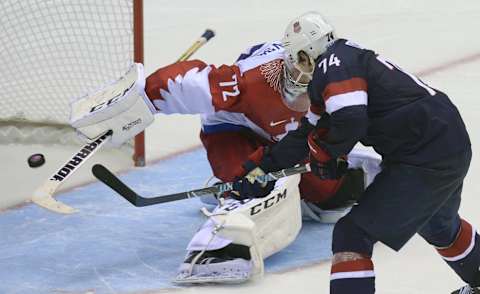 US Tj Oshie scores past Russia’s goalkeeper Sergei Bobrovski during a penalty shootout session at the end of the Men’s Ice Hockey Group A match USA vs Russia at the Bolshoy Ice Dome during the Sochi Winter Olympics on February 15, 2014 in Sochi. US won 3-2 in the penalty shootout. AFP PHOTO / ALEXANDER NEMENOV (Photo credit should read ALEXANDER NEMENOV/AFP/Getty Images)