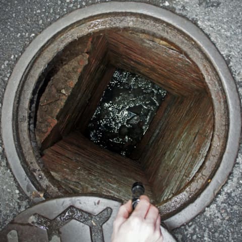 Water at the bottom of a Manhattan manhole, which some urban explorers suggest is the remnants of the Minetta Brook.