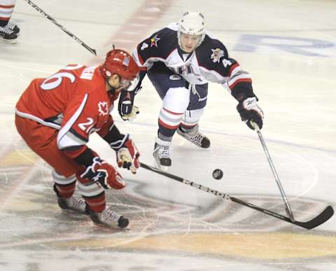 John Ewing/Staff Photographer — John Carlson, right, of the Hershey Bears has done it all this month. He played for Team USA in the world junior hockey championships, got called up by the Washington Capitals for two games, and was an AHL all-star. — (Photo by John Ewing/Portland Press Herald via Getty Images)