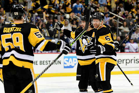 PITTSBURGH, PENNSYLVANIA – MAY 09: Mike Matheson #5 of the Pittsburgh Penguins celebrates his goal with Kris Letang #58 and Jake Guentzel #59 during the second period of Game Four of the First Round of the 2022 Stanley Cup Playoffs against the New York Rangers at PPG PAINTS Arena on May 09, 2022 in Pittsburgh, Pennsylvania. (Photo by Emilee Chinn/Getty Images)