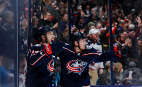 Feb 14, 2020; Columbus, Ohio, USA; celebrates with teammate center Gustav Nyquist (14) after scoring a goal against the New York Rangers in the second period at Nationwide Arena. Mandatory Credit: Aaron Doster-USA TODAY Sports