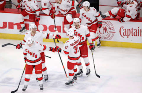 Feb 2, 2021; Chicago, Illinois, USA; Carolina Hurricanes right wing Andrei Svechnikov (37) celebrates with teammates after scoring a goal against the Chicago Blackhawks during a shoot-out at United Center. Mandatory Credit: Kamil Krzaczynski-USA TODAY Sports