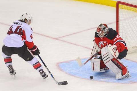 Jan 21, 2016; Newark, NJ, USA; New Jersey Devils goalie Cory Schneider (35) makes a save on Ottawa Senators center Jean-Gabriel Pageau (44) during the third period at Prudential Center. The Devils defeated the Senators 6-3. Mandatory Credit: Ed Mulholland-USA TODAY Sports