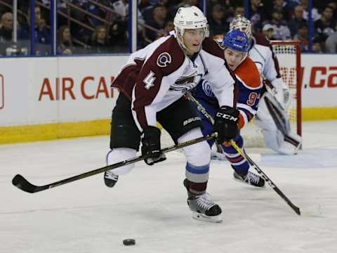 Feb 20, 2016; Edmonton, Alberta, CAN; Edmonton Oilers forward Connor McDavid (97) tries to check Colorado Avalanche defensemen Tyson Barrie (4) during the first period at Rexall Place. Mandatory Credit: Perry Nelson-USA TODAY Sports