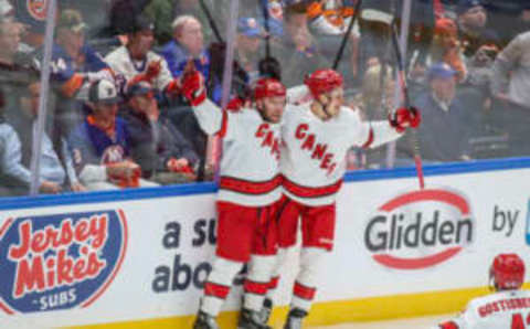 Apr 28, 2023; Elmont, New York, USA; Carolina Hurricanes center Paul Stastny (26) celebrates with right wing Jesse Puljujarvi (13) after scoring the game-winning goal in overtime to defeat the New York Islanders 2-1 in game six of the first round of the 2023 Stanley Cup Playoffs at UBS Arena. Mandatory Credit: Wendell Cruz-USA TODAY Sports