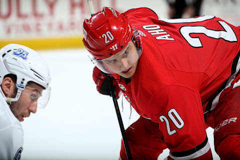 RALEIGH, NC – APRIL 7: Sebastian Aho #20 of the Carolina Hurricanes and Tyler Johnson #9 of the Tampa Bay Lightning prepare for a faceoff during an NHL game on April 7, 2018 at PNC Arena in Raleigh, North Carolina. (Photo by Gregg Forwerck/NHLI via Getty Images)