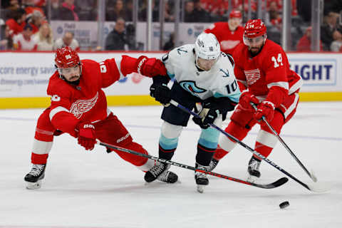 Mar 2, 2023; Detroit, Michigan, USA; Detroit Red Wings defenseman Jake Walman (96) Seattle Kraken center Matty Beniers (10) and center Robby Fabbri (14) battle for the puck in the third period at Little Caesars Arena. Mandatory Credit: Rick Osentoski-USA TODAY Sports