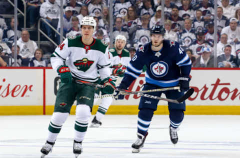 WINNIPEG, MB – APRIL 20: Joel Eriksson Ek #14 of the Minnesota Wild and Joel Armia #40 of the Winnipeg Jets follow the play down the ice during first period action in Game Five of the Western Conference First Round during the 2018 NHL Stanley Cup Playoffs at the Bell MTS Place on April 20, 2018 in Winnipeg, Manitoba, Canada. The Jets defeated the Wild 5-0 and won the series 4-1. (Photo by Jonathan Kozub/NHLI via Getty Images)