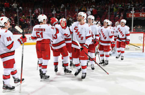 GLENDALE, ARIZONA – FEBRUARY 06: Joel Edmundson #6 of the Carolina Hurricanes congratulates Jake Gardiner #51 and teammates following a 5-3 victory against the Arizona Coyotes during the NHL hockey game at Gila River Arena on February 06, 2020 in Glendale, Arizona. (Photo by Norm Hall/NHLI via Getty Images)